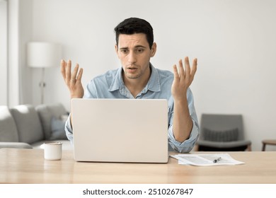 Concerned puzzled Latin freelance worker man looking at laptop with confused hand gesture. Frustrated worried computer user getting bad news, job technology failure, feeling shock, stress. - Powered by Shutterstock