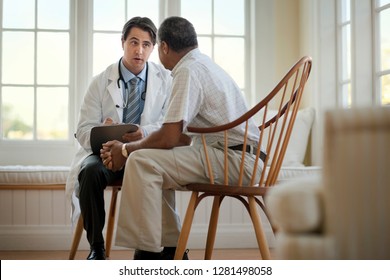 Concerned Senior Man Talking Over Healthcare Options With His Family Doctor.