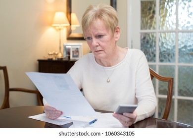 Concerned Senior Woman Reviewing Domestic Finances