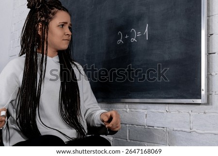 A Concerned Student Facing a Challenging Math Problem on the Chalkboard in Class