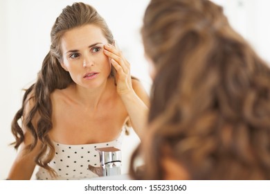 Concerned Woman Checking Facial Skin Condition In Bathroom