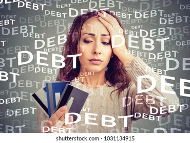 Concerned woman looking at many credit cards scared with huge amount of debt.