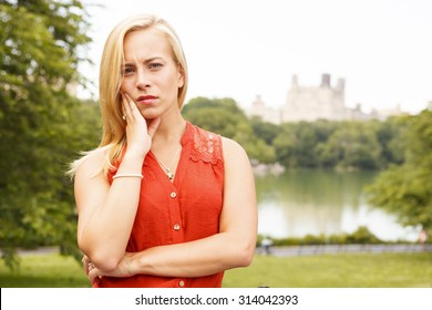 A Concerned Woman Makes Eye Contact With Viewer.