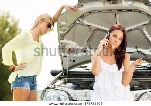 Concerned young tourist woman making phone\
call and ask for help because of Car\
troubles.