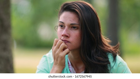 Concerned young woman thinking at park. Worried pensive girl. - Shutterstock ID 1672567945