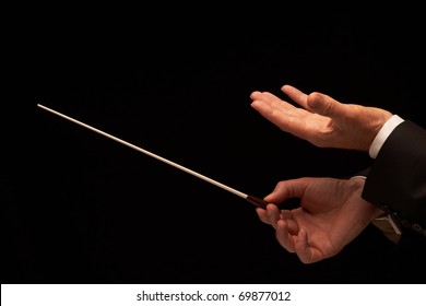 Concert Conductor Hands With Baton Isolated On Black Background