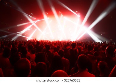 Concert Crowd Of Young People In Front Of Bright Stage Lights