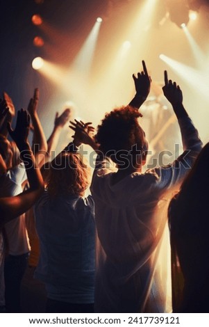Concert, fans and people dance to music, event and lights on stage for performance at festival. Nightclub, party and back of audience or excited crowd listening to musician and sound with freedom