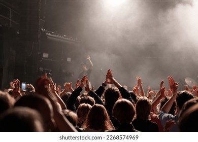 concert hall crowd hands up