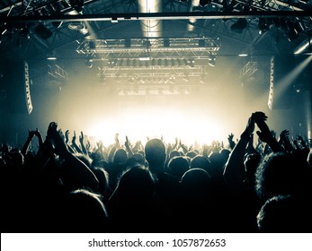 Concert Venue With Lit Stage And Fans In Front Of It