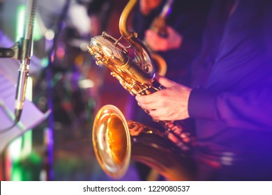 Concert View Of A Saxophone Player With Vocalist And Musical Jazz Band In The Background
