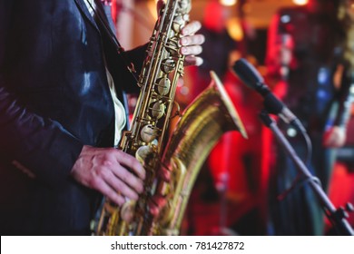 Concert View Of A Saxophone Player With Vocalist And Musical Jazz Band In The Background