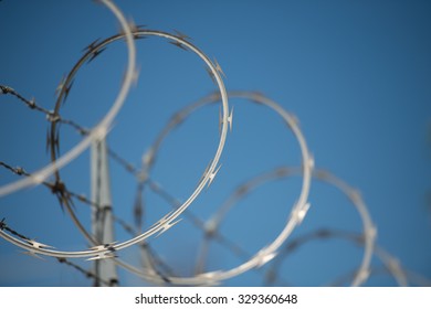 Concertina razor wire and barbed wire on a security fence