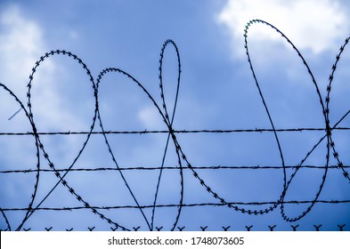 Concertina Wire Against A Stormy Sky