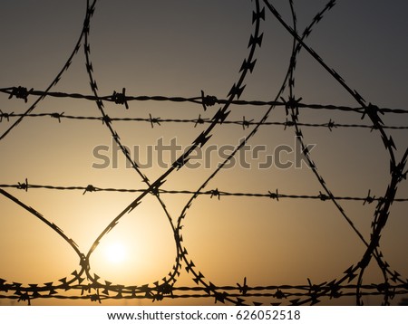 Similar – Fence with a barbed