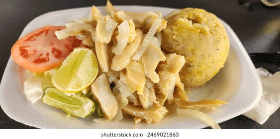 Conch salad with mofongo. This is a puertorrican dish. The mofongo is made with smashed plantains and garlic.