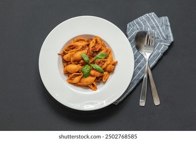 Conchiglie pasta with tomato sauce. Conchiglie pasta is shaped like a shell. - Powered by Shutterstock