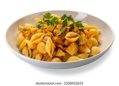 Conchiglie rigate pasta. Macaroni in shape of ridged shell with courgette and tomato sauce with parsley leaves in white dish isolated on white with clipping path included - Powered by Shutterstock