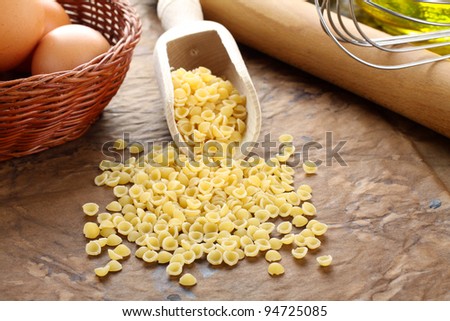 Conchigliette raw pasta on complex background