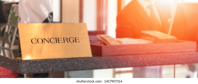 Concierge Service Desk Counter With Staff Team Working In Front Of Hotel With Tourist Business Customer. 