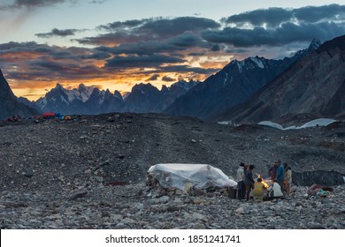 Concordia / Pakistan - 08/14/2018: Porters Next To Campfire In Concordia During Sunset, K2 Base Camp Trek, Karakoram