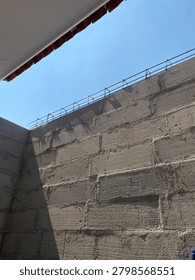 Concreate brick wali structure with bluesky background. Suitable for construction, architecture, and building material concept