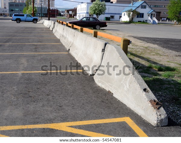 Concrete Barrier between\
parking lots