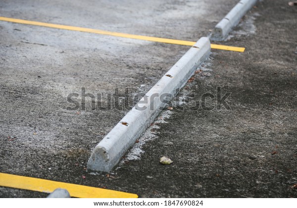 Concrete\
barrier stop car wheels in the car\
parking.