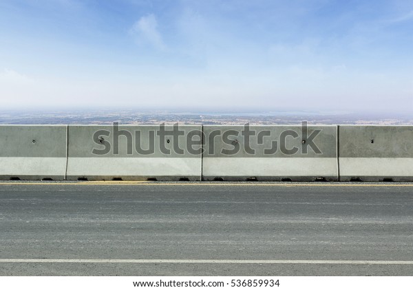 concrete barriers blocking the\
road