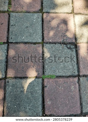 concrete block footpath on the side of the road