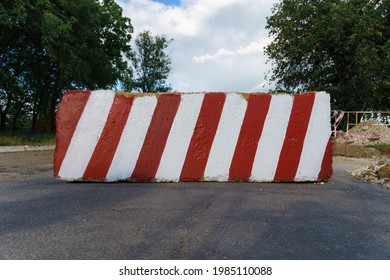 Concrete Block With Red And White Striped Lines As A Roadblock, Traffic Is Prohibited And Road Works, The Road Is Closed For Maintenance