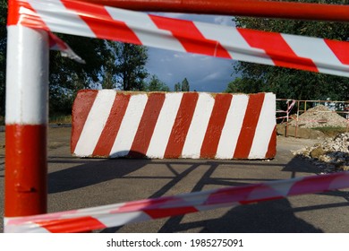 Concrete Block With Red And White Striped Lines As A Roadblock, Traffic Is Prohibited And Road Works, The Road Is Closed For Maintenance