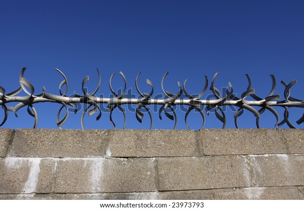 concrete block wall with
metal spikes