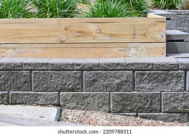 Concrete block wall with a pine sleeper garden bed - Shutterstock ID 2209788311