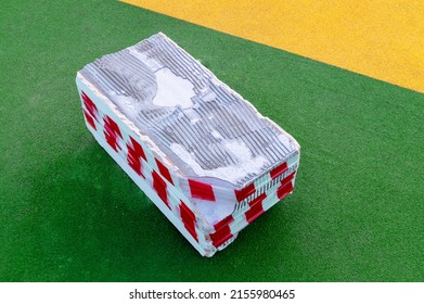 concrete block wrapped with restrictive tape - Shutterstock ID 2155980465