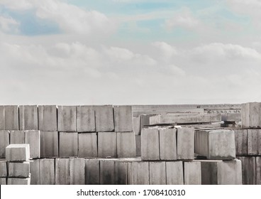 Concrete blocks at a construction site. Concrete structures in an industrial area against a cloudy sky