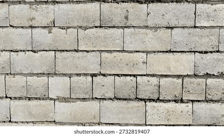 Concrete blocks create rustic surface. Worn industrial brick surface displaying textured gray masonry. Weathered concrete masonry showing signs of aging with mortar joints and textured surfaces