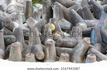 Concrete breakwaters made of tetrapod blocks. Breakwater on the beach and dunes. Concrete blocks on the beach. Stock fotó © 
