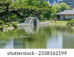 Concrete bridge over man made lake in Shukkeien gardens in Hiroshima.