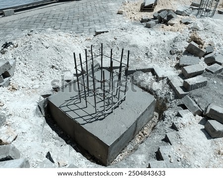 Concrete building construction site. Concrete slab of building foundation. Foundation pit with concrete piles reinforcement. Steel rebar of concrete piles, foundation slab