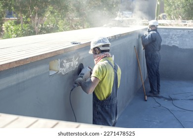 Concrete ceiling surface of the pool grinding by angle grinder. Construction concept