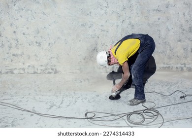 Concrete ceiling surface of the pool grinding by angle grinder. Construction concept