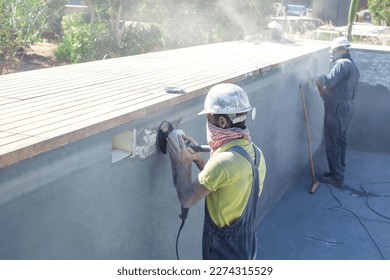 Concrete ceiling surface of the pool grinding by angle grinder. Construction concept