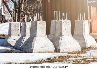 Concrete column foundations stacked at the construction site.
