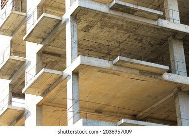 Concrete construction new high  rise apartment building  An unfinished buildings facade view from outside  Residential complex exterior  Real estate investment  Slabs  walls without windows  