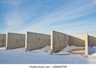 Concrete construction on the background of the winter landscape is covered with snow. Frosty sunny day. - Powered by Shutterstock