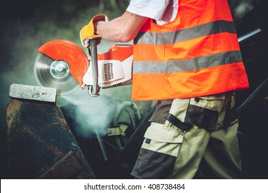 Concrete Cutting Construction Power Tool Closeup Photo. Construction Worker Cutting Concrete Block Using Electric Cutter.