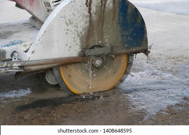 Concrete cutting machine are cutting concrete floor using cast water to reduce dust spread.