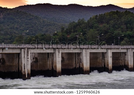 concrete dam block water mass between mountain for generate electricity by water gravity power 
