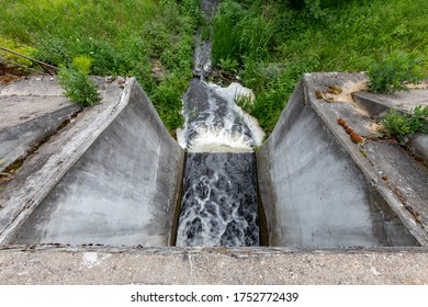 Concrete Dam Seen From Above. Small Hydropower Plant. Spring Season.